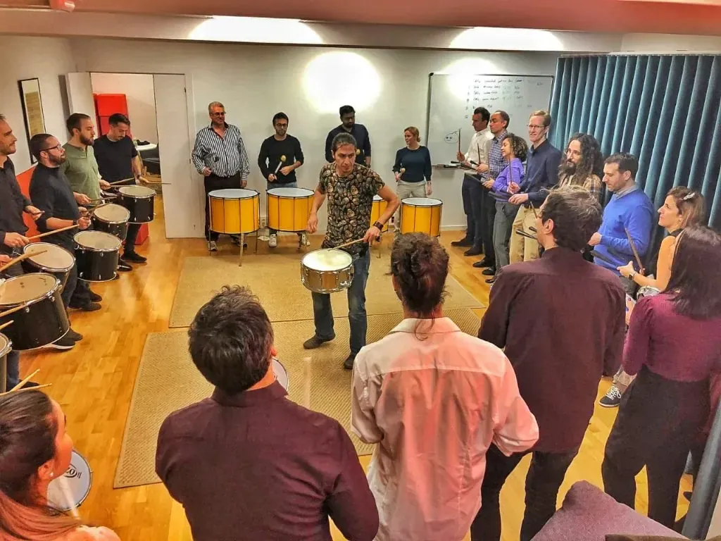 Equipo de empresa posando con los tambores tras una experiencia TOCART